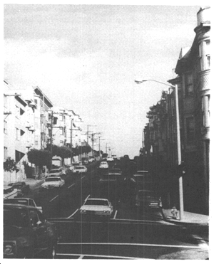 a wide, multi-lane, busy residential street